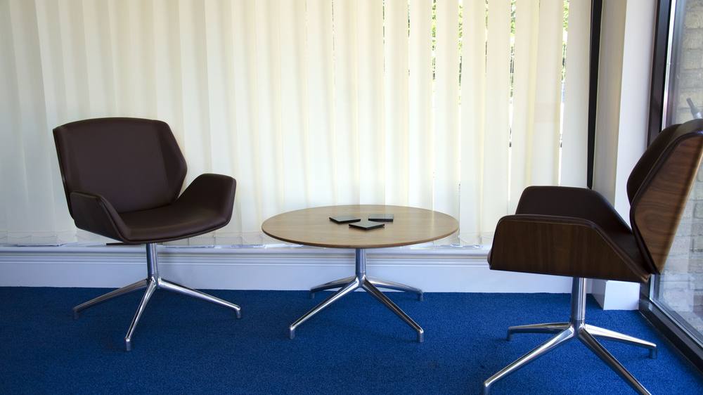 Informal seating by a window, with two armchairs and a low table