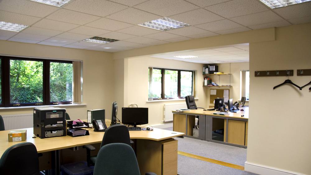A larger suite laid out as an open plan office with several desks