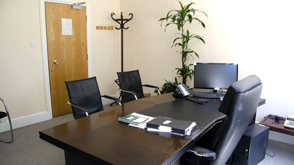 A suite set up for one person, with visitor chairs